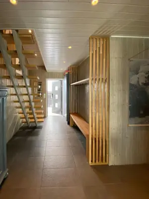 a hallway with wooden stairs in a house at Enjoy Family Time In Beautiful Nature in Krøderen