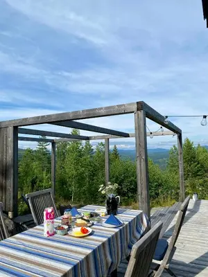 a table with a blue and white striped table cloth at Enjoy Family Time In Beautiful Nature in Krøderen