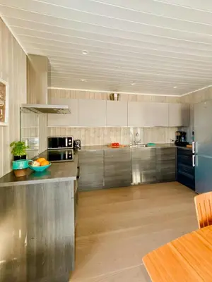 a large kitchen with a stainless steel counter top at Enjoy Family Time In Beautiful Nature in Krøderen