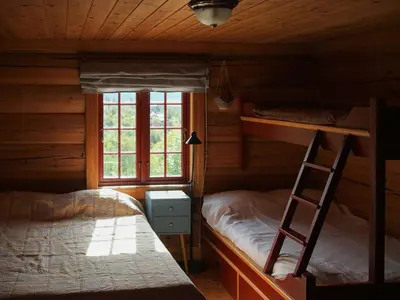 a bedroom with two bunk beds and a ladder at Cabin With Wooden Interior By Lake Tinnsjøen in Atra