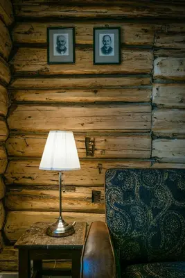 a lamp sitting on a table next to a chair at Family-Friendly Cabin With Agricultural Idyll in Vestre Gausdal