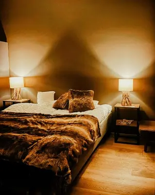 a bedroom with a large bed with two lamps at Modern Flat In Trysil Alpine Lodge in Trysil