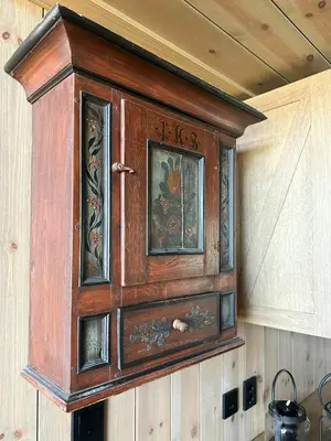 a wooden cabinet hanging on a wall at Peaceful Cabin By Rødungen in Ål