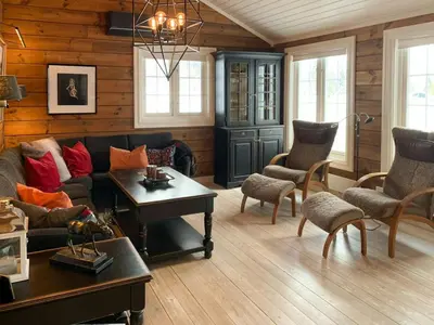 a living room with a couch and chairs and a table at Mountain Home At Haglebu With Activities in Eggedal