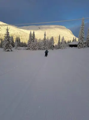a person walking across a snow covered field at Mountain Home At Haglebu With Activities in Eggedal