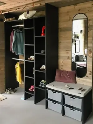 a walk in closet with a bench and a mirror at Enjoy Simple Cabin Life In Nature in Kongsberg