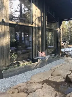 a house with a large window on the side of it at Enjoy Simple Cabin Life In Nature in Kongsberg