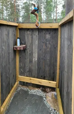 a bird on the side of a wooden fence at Enjoy Simple Cabin Life In Nature in Kongsberg