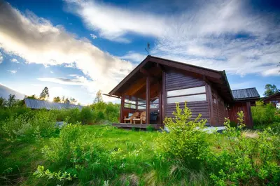 a small wooden cabin in a field of grass at Relaxing Mountain Cabin With Panoramic Views in Beitostøl