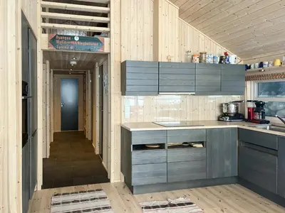 a kitchen with gray cabinets and a hallway at Modern Ål Cabin At The Foot Of Reinskarvet in Ål