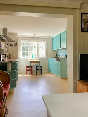 a kitchen with blue cabinets and a table in it at Fantastic Charming Cabin By Tinnsjøen in Austbygdi