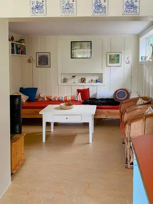 a living room with a couch and a table at Fantastic Charming Cabin By Tinnsjøen in Austbygdi