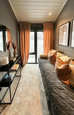 a living room with a couch and a large window at Luxury By The Fjord In Ranvik in Eidsvåg