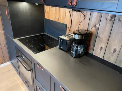 a kitchen counter with a coffeemaker on a counter top at Hafjell Alpinlandsby Apartment 43 in Hafjell