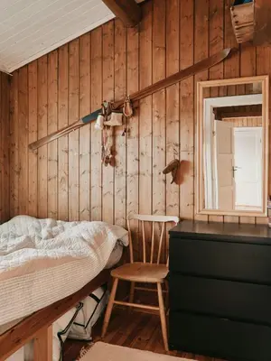 a bedroom with a bed and a chair and a mirror at Cabin In Uvdal With A View Ski-Inout in Uvdal
