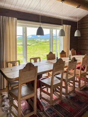 a dining room with a large wooden table and chairs at Spacious Family Cabin Near Nordre Syndin in Ryfoss