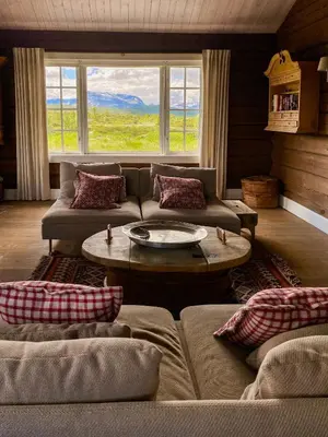 a living room with a couch and a table at Spacious Family Cabin Near Nordre Syndin in Ryfoss