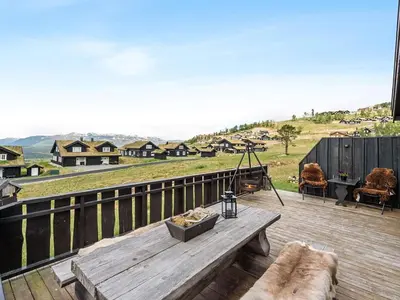 a wooden deck with a bench on top of it at 9 person holiday home in Rauland in Rauland