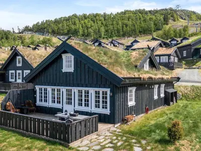 an image of a black house with a grass roof at 9 person holiday home in Rauland in Rauland