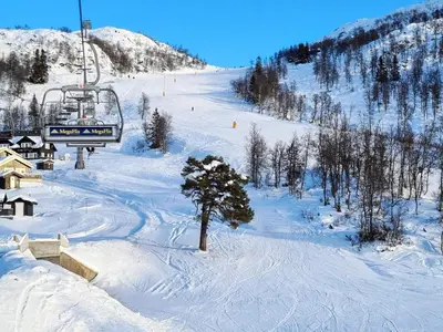 a snow covered ski slope with a ski lift at 9 person holiday home in Rauland in Rauland