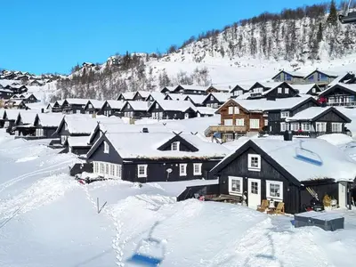 a group of houses covered in snow at 9 person holiday home in Rauland in Rauland