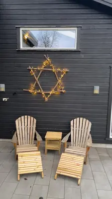 two chairs and a star sign on a wall at A home away from home in Sogndal