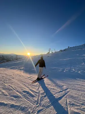 a person is skiing down a snow covered slope at A home away from home in Sogndal