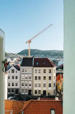 a view of a building with a crane in the background at Unique apartment-Romantic Street-Easy Check-In in Bergen