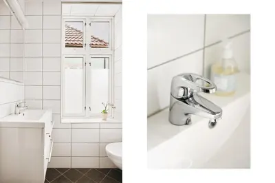 a white bathroom with a sink and a mirror at Unique apartment-Romantic Street-Easy Check-In in Bergen