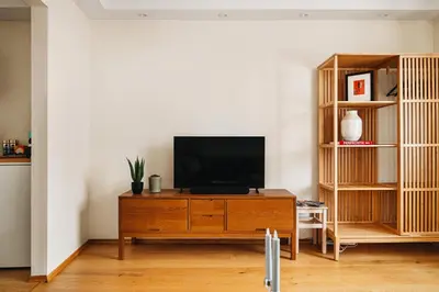 a living room with a television on a wooden cabinet at Unique apartment-Romantic Street-Easy Check-In in Bergen