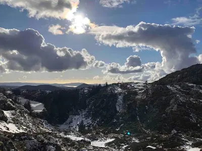 a view of a snowy mountain with clouds in the sky at In the heart of Bergen in Bergen