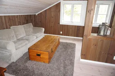 a living room with a couch and a coffee table at Moderne hytte plass for 10 in Rendalen