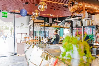 a woman sitting at the counter of a restaurant at Hotel Oleana in Bergen