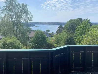 a balcony with a view of a lake at 4 person holiday home in Kjerrgarden in Kjerrgarden