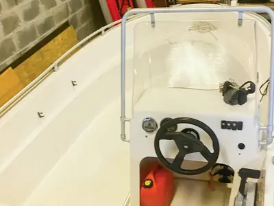 a speedboat with a steering wheel sitting on the side of a stair case at 4 person holiday home in Kjerrgarden in Kjerrgarden