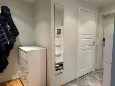 a room with a closet with a mirror and a door at World championship, VM på ski Granåsen 2025 in Trondheim