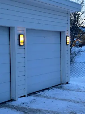 two garage doors with lights in a snowy garage at World championship, VM på ski Granåsen 2025 in Trondheim