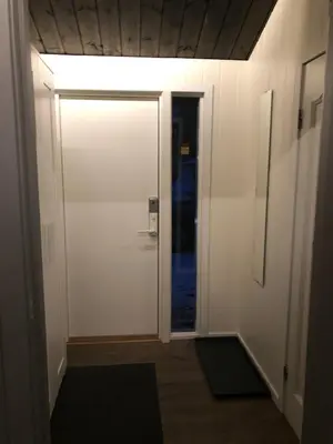 a hallway with a white door with a light at Cozy cabin 1,5 hours from Oslo in Hamar