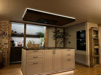 a kitchen with white cabinets and a counter top at Cabin with large outdoor area in Hamar