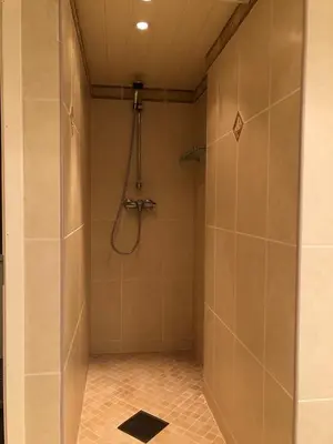 a bathroom with a shower with a glass door at Cabin with large outdoor area in Hamar