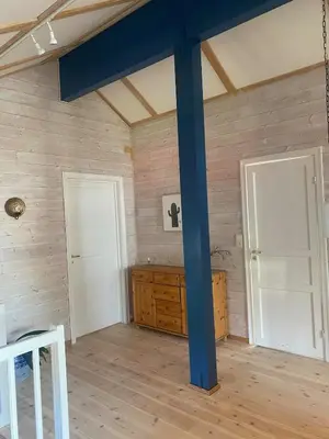 a room with two white doors and a blue pole at SKI VM House 5 min walk to Granåsen ski stadion in Trondheim