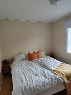 a bedroom with a white bed with two pillows at SKI VM House 5 min walk to Granåsen ski stadion in Trondheim