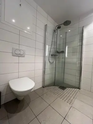 a bathroom with a toilet and a shower at Attraktiv utsiktsleilighet in Ranheim