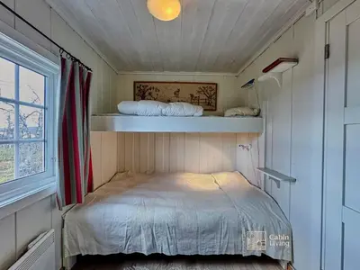 a small room with a bed and a window at Cozy cabin near Geilo & Dagali terrace, grill, fireplace, view & WiFi in Hol