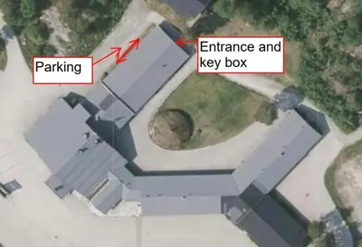 an aerial view of a building with an entrance and key box at Cozy apartment with pool in Bjorli