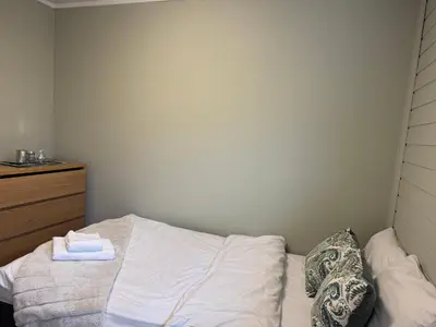 a bedroom with a bed with a towel on it at Small apartment in Elnesvågen in Svinøya