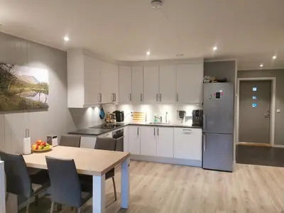 a kitchen with a table and a refrigerator at Lovely apartment with stunning views in Torset