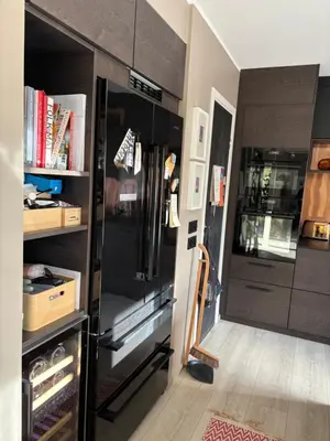 a kitchen with a black refrigerator in a room at Modern & cozy house in Trondheim