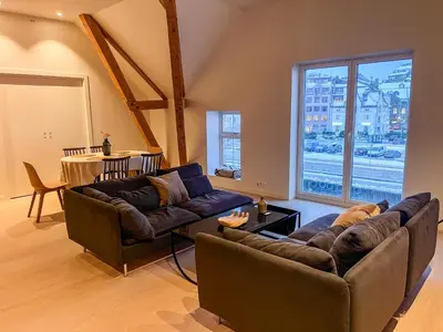 a living room with two couches and a large window at MARINA LUXE - Two Bedrooms, High-End, Iconic Location & Private Parking in Ålesund