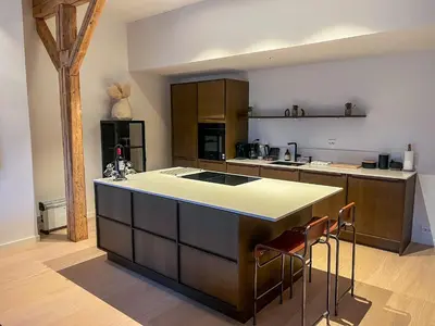 a kitchen with a large island in the middle at MARINA LUXE - Two Bedrooms, High-End, Iconic Location & Private Parking in Ålesund